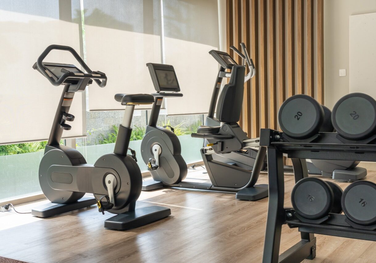 Modern sport bike and dumbbells in fitness room